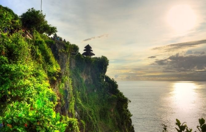Uluwatu Temple perched on dramatic cliff above the Indian Ocean in Bali